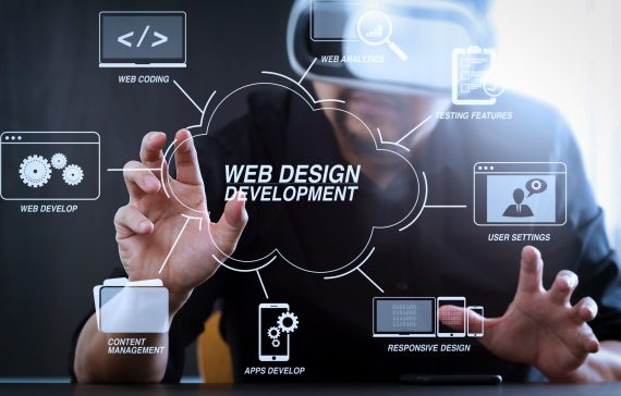 Developing programming and coding technologies with Website design in virtual diagram.businessman wearing virtual reality goggles in modern office with mobile phone using with VR headset